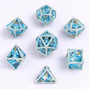 Skull's Grin Hollow Metal Dice Set - Glow in the Dark Blue